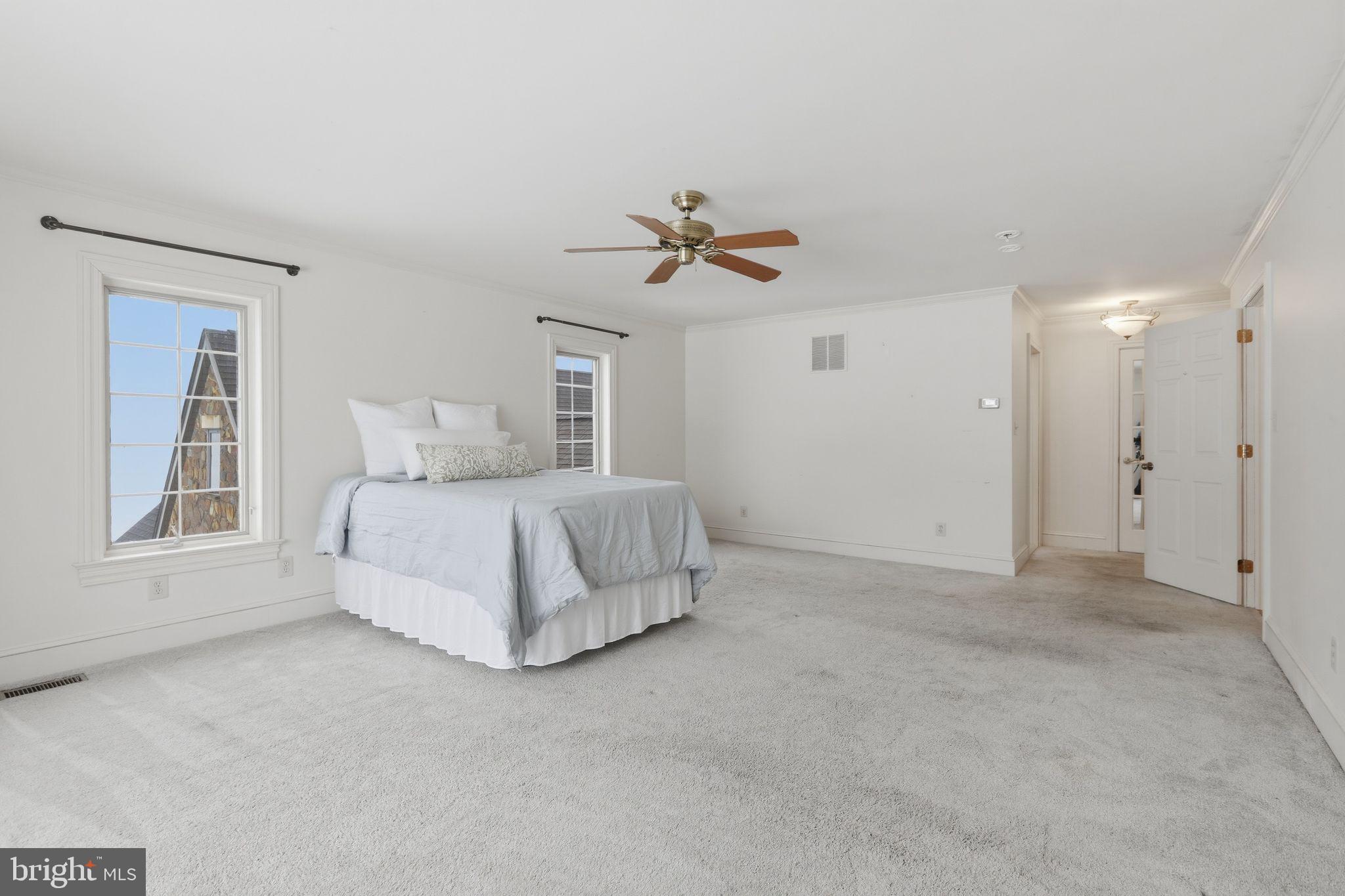 231 Hill Road Elverson, PA 19520 - Photo 32 of 60 a bed room with a bed and a ceiling fan