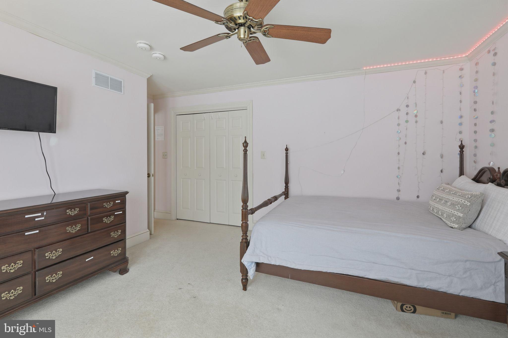 231 Hill Road Elverson, PA 19520 - Photo 45 of 60 a bedroom with a bed and a flat tv screen on the dresser