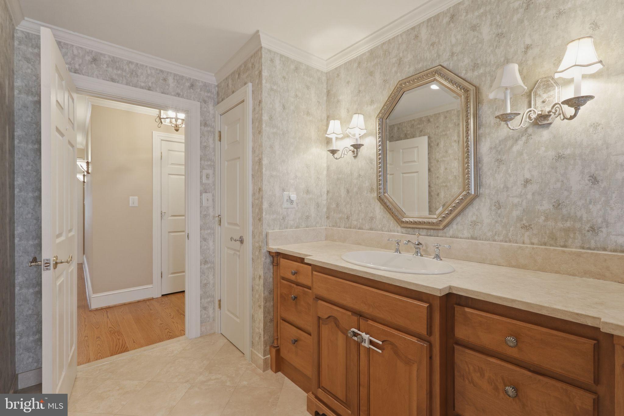 231 Hill Road Elverson, PA 19520 - Photo 47 of 60 a bathroom with a granite countertop sink a mirror and a shower