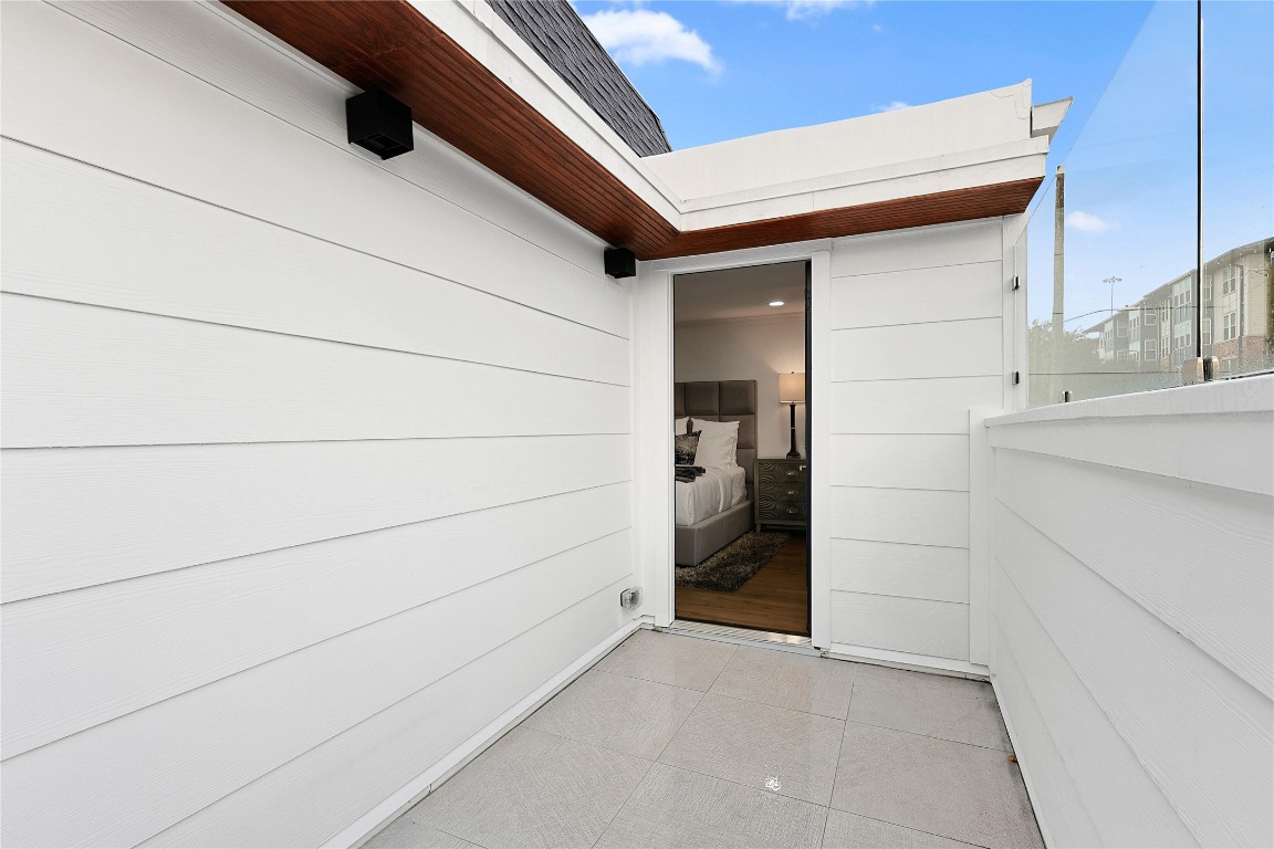 526 Colquitt Street Houston, TX 77006 - Photo 22 of 30 The main bedroom private balcony featuring wood-accented ceiling creates a seamless indoor-outdoor living space