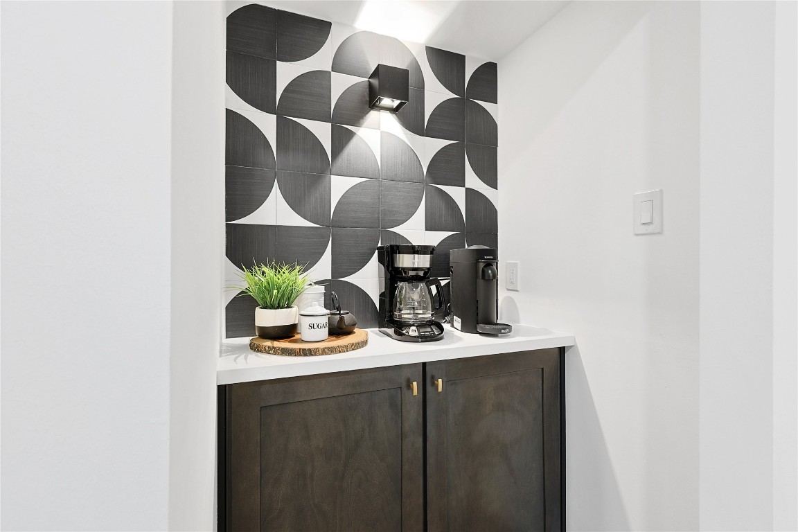 526 Colquitt Street Houston, TX 77006 - Photo 9 of 30 A stylish coffee nook adjacent to the dining area features a modern black-and-white geometric tile backsplash. The coffee maker is ready for your morning brews.