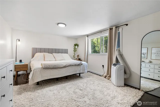 a spacious bedroom with a bed and a window