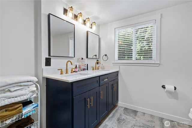 a bathroom with a sink vanity and a mirror