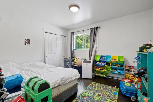 a bedroom with furniture and a wooden floor