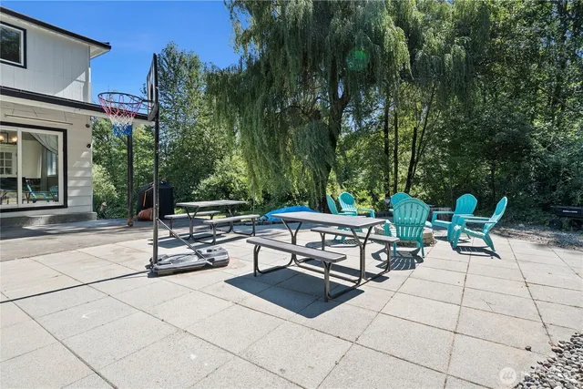 a view of a house with backyard and sitting area