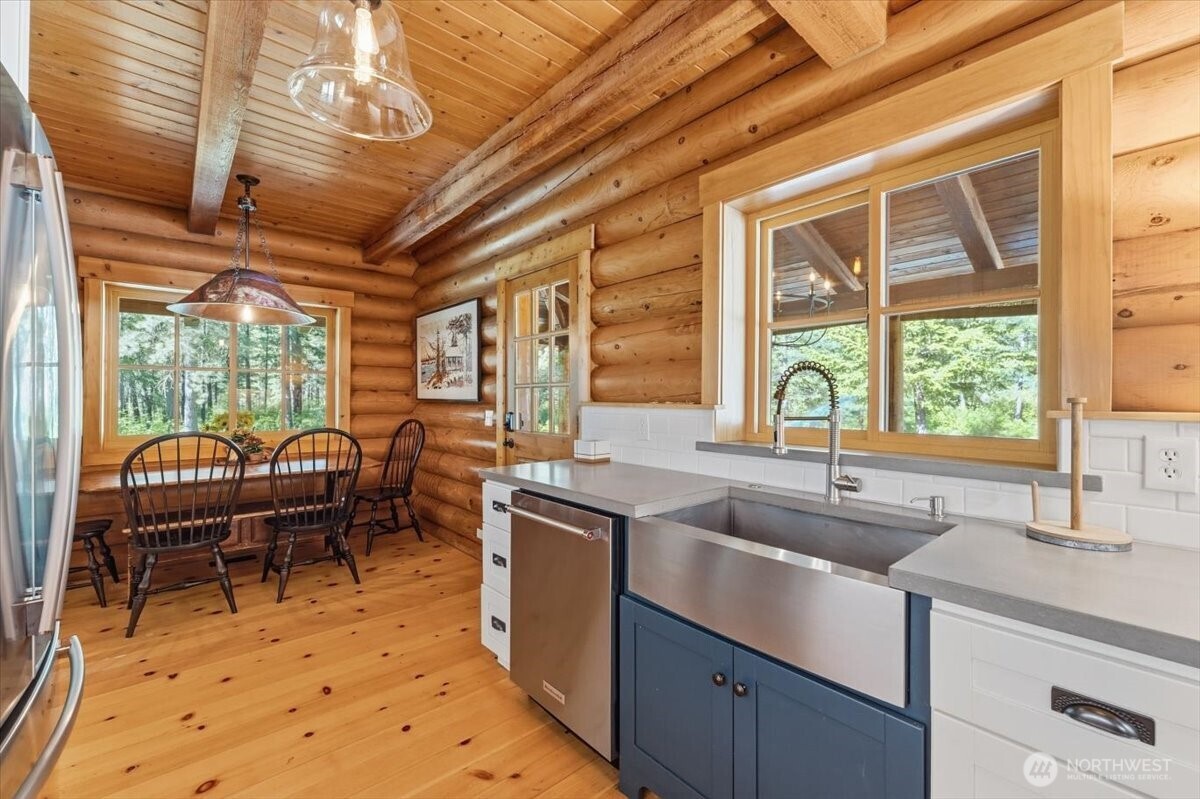 2250 First Crk Road Chelan, WA 98816 - Photo 14 of 39 a kitchen with a sink and wooden cabinets