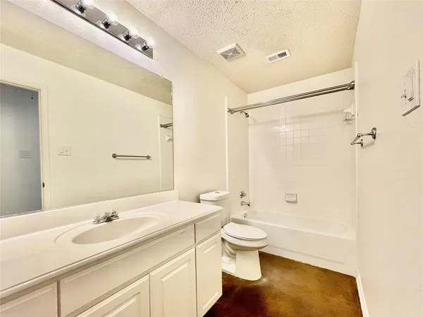 a bathroom with a sink a toilet and a large mirror