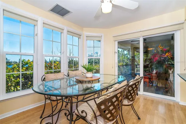 a living room with furniture a wooden floor and next to a large window