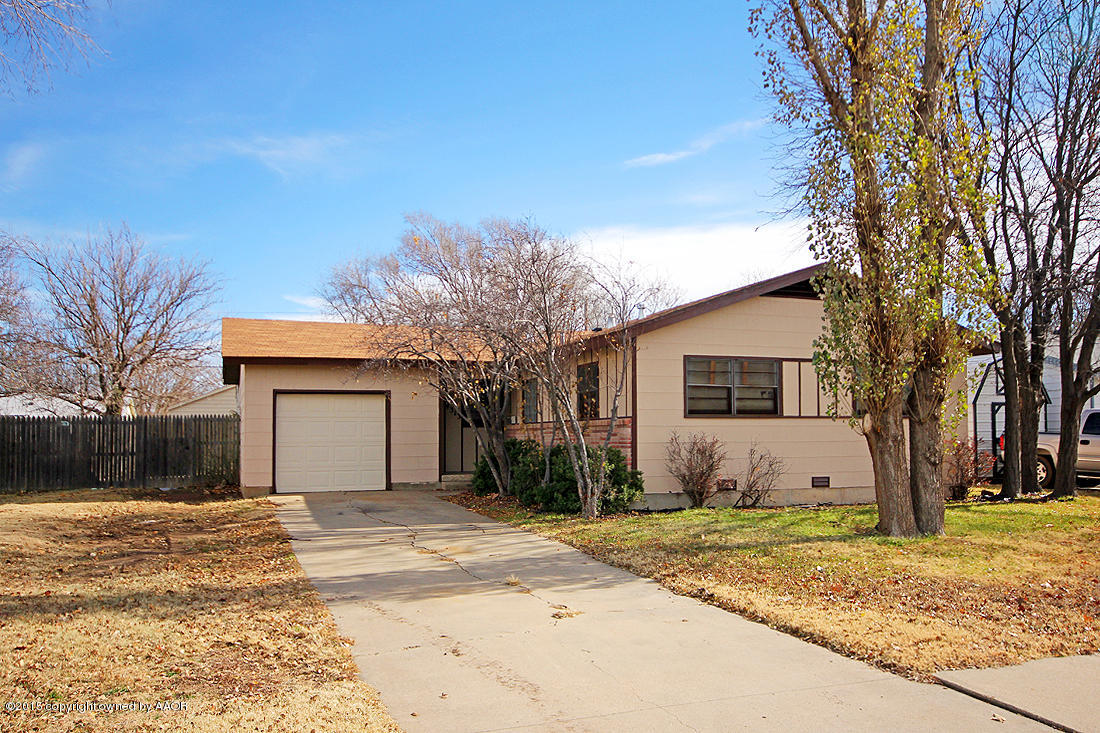 4313 South Bonham Street Amarillo, TX 79110 - Photo 1 of 21 a front view of a house with a yard and garage