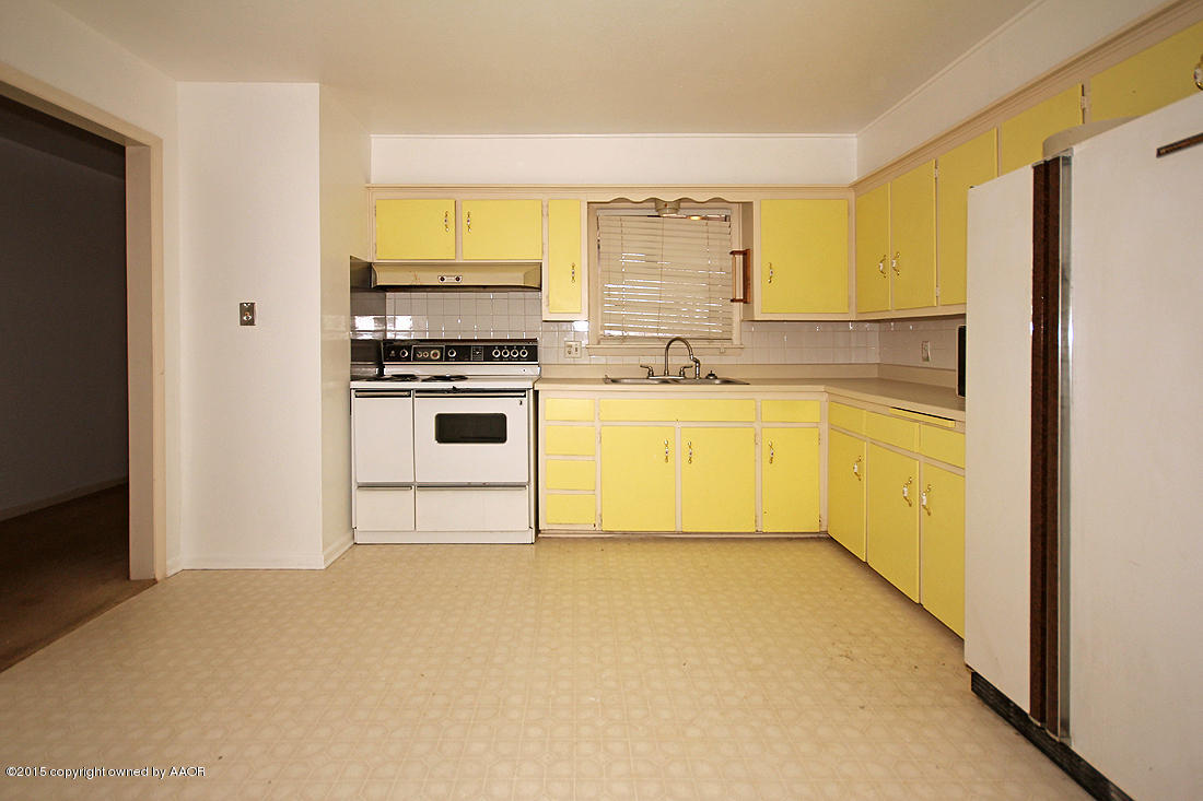 4313 South Bonham Street Amarillo, TX 79110 - Photo 7 of 21 a kitchen with stainless steel appliances a stove a sink and a refrigerator