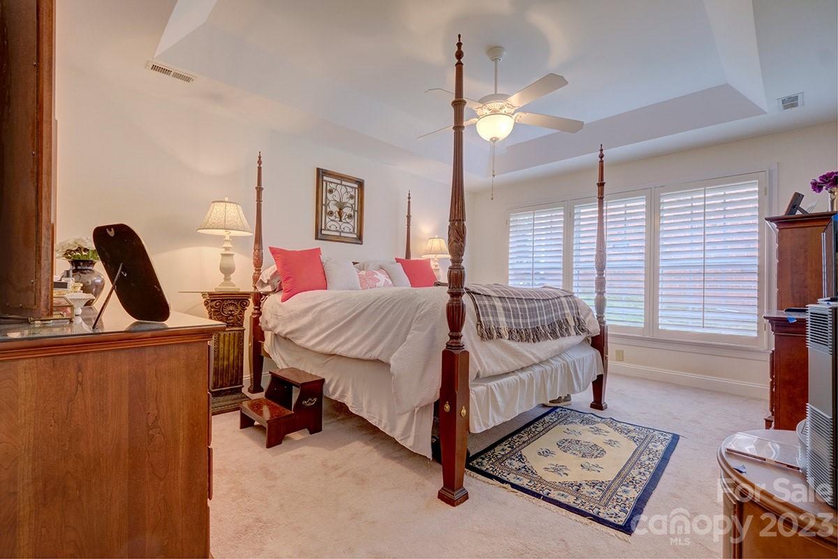 1129 Blowing Rock Cove Fort Mill, SC 29708 - Photo 16 of 37 a bedroom with a bed a couch and dresser with the floor