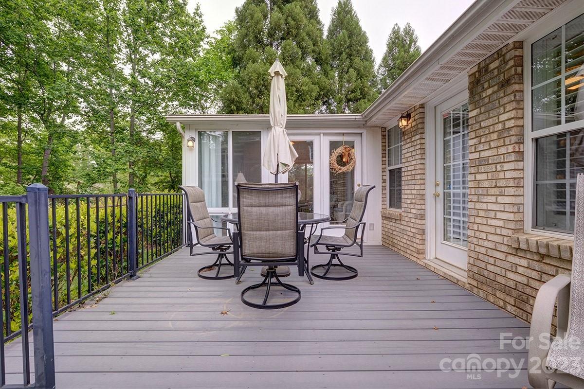1129 Blowing Rock Cove Fort Mill, SC 29708 - Photo 31 of 37 a view of a patio with table and chairs with wooden floor and fence