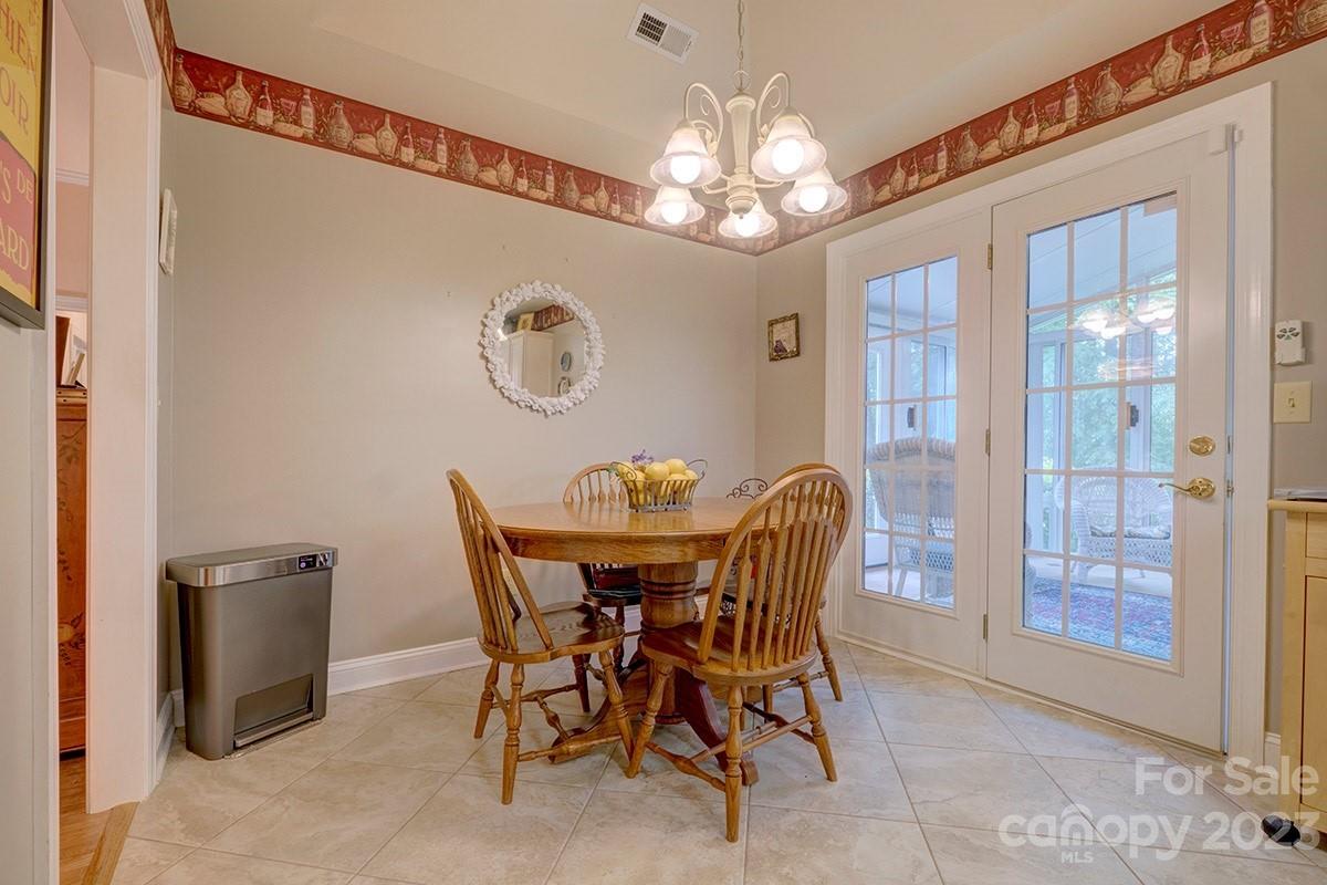 1129 Blowing Rock Cove Fort Mill, SC 29708 - Photo 10 of 37 a view of a dining room with furniture and chandelier