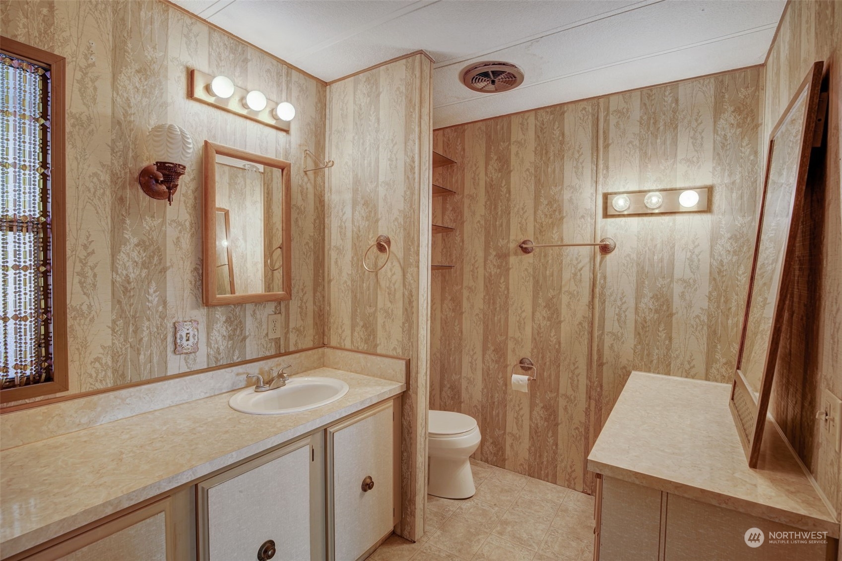 23708 Locust Way, Unit 28A Bothell, WA 98021 - Photo 21 of 40 a bathroom with a sink a toilet a mirror and shower