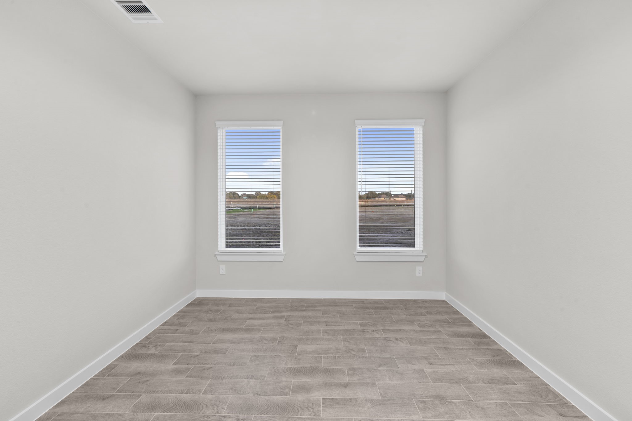 3015 Boulder Ridge Drive Rosenberg, TX 77471 - Photo 12 of 34 a view of an empty room with wooden floor and a window