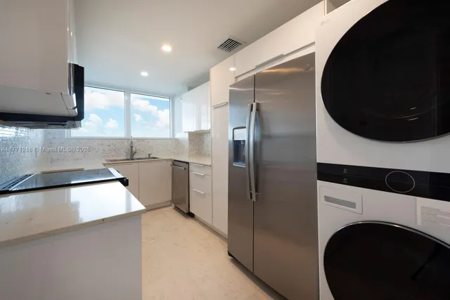 a kitchen with stainless steel appliances granite countertop a sink and a microwave