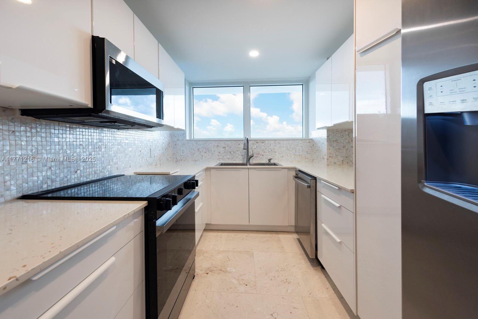 333 Sunset Drive, Unit 804 Fort Lauderdale, FL 33301 - Photo 14 of 28 a kitchen with stainless steel appliances granite countertop a sink and a microwave