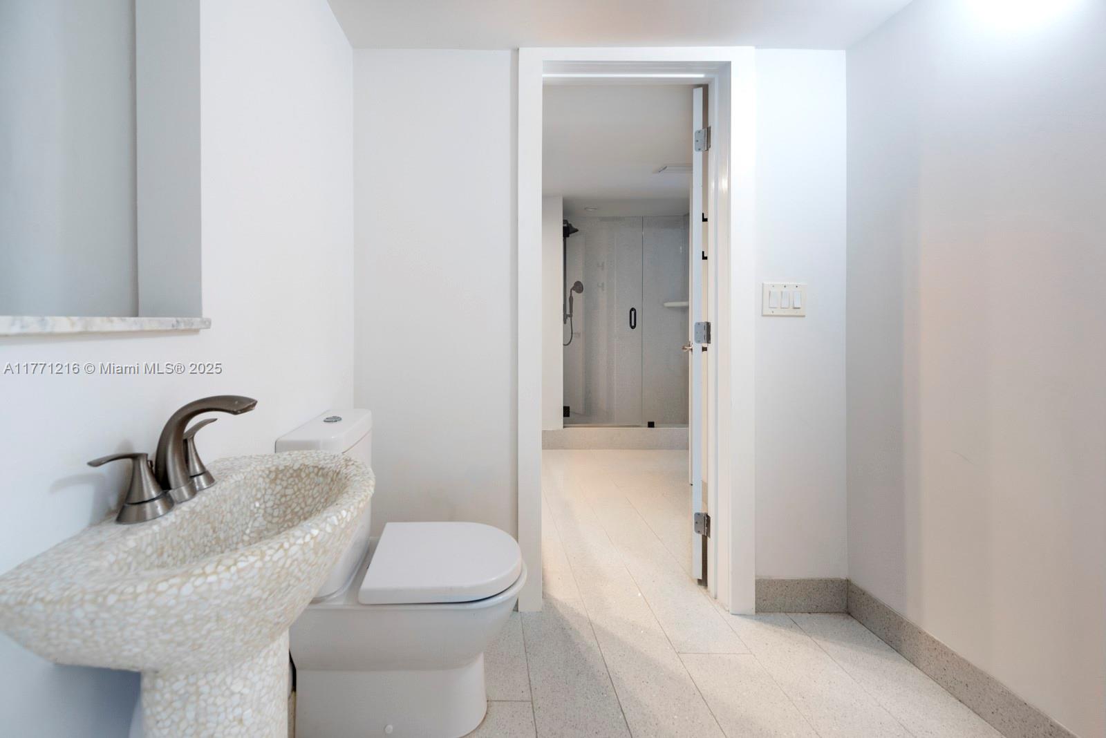 333 Sunset Drive, Unit 804 Fort Lauderdale, FL 33301 - Photo 15 of 28 a bathroom with a toilet sink and shower