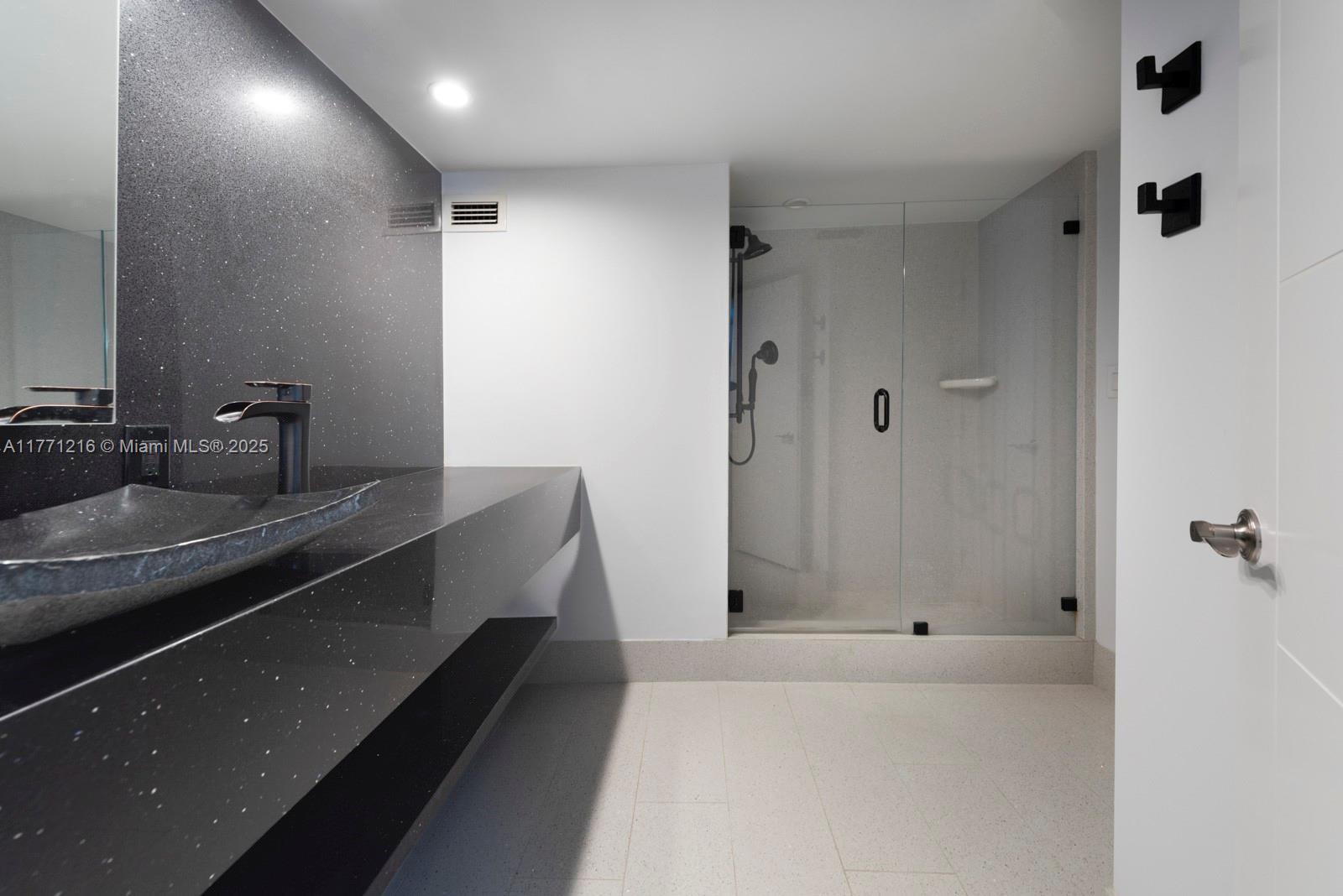 333 Sunset Drive, Unit 804 Fort Lauderdale, FL 33301 - Photo 18 of 28 a bathroom with a sink and a mirror