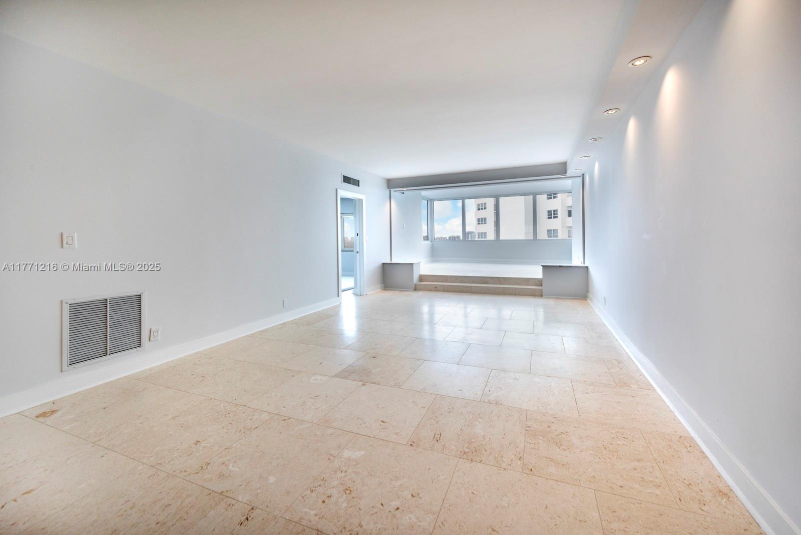 333 Sunset Drive, Unit 804 Fort Lauderdale, FL 33301 - Photo 5 of 28 a view of empty room with a fireplace and a window