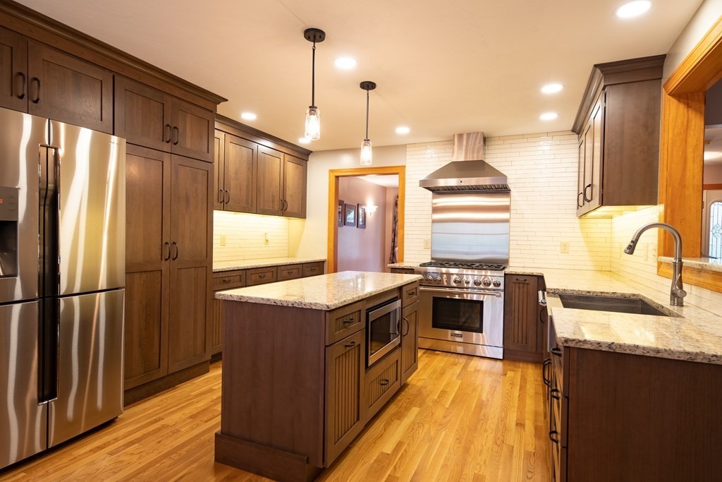 48 Easter Brook Road Lunenburg, MA 01462 - Photo 14 of 38 a kitchen with stainless steel appliances granite countertop hardwood floor sink stove and refrigerator