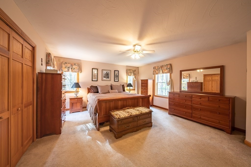 48 Easter Brook Road Lunenburg, MA 01462 - Photo 25 of 38 a spacious bedroom with a bed couch chandelier and a window