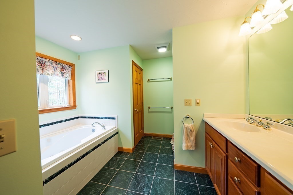 48 Easter Brook Road Lunenburg, MA 01462 - Photo 26 of 38 a bathroom with a tub a sink and a mirror