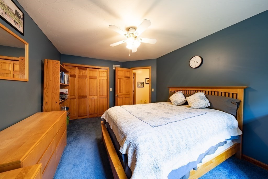 48 Easter Brook Road Lunenburg, MA 01462 - Photo 29 of 38 a spacious bedroom with a bed and a chandelier