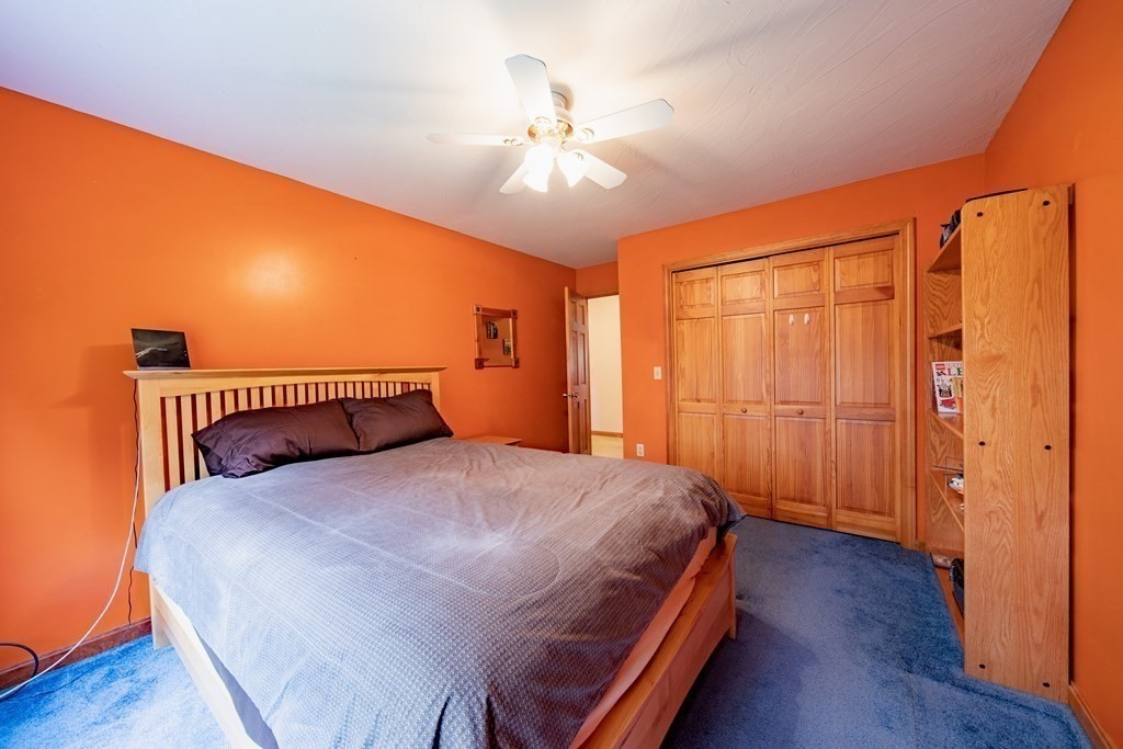 48 Easter Brook Road Lunenburg, MA 01462 - Photo 30 of 38 a bedroom with a large bed and a chandelier