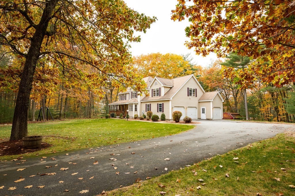 48 Easter Brook Road Lunenburg, MA 01462 - Photo 3 of 38 a front view of a house with a yard and trees