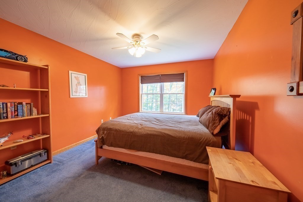 48 Easter Brook Road Lunenburg, MA 01462 - Photo 31 of 38 a bedroom with a bed and a chandelier