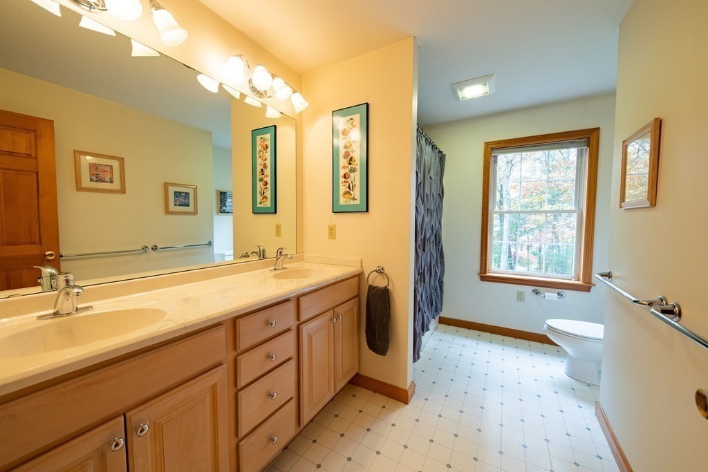 48 Easter Brook Road Lunenburg, MA 01462 - Photo 32 of 38 a spacious bathroom with sinks mirror and a bathtub