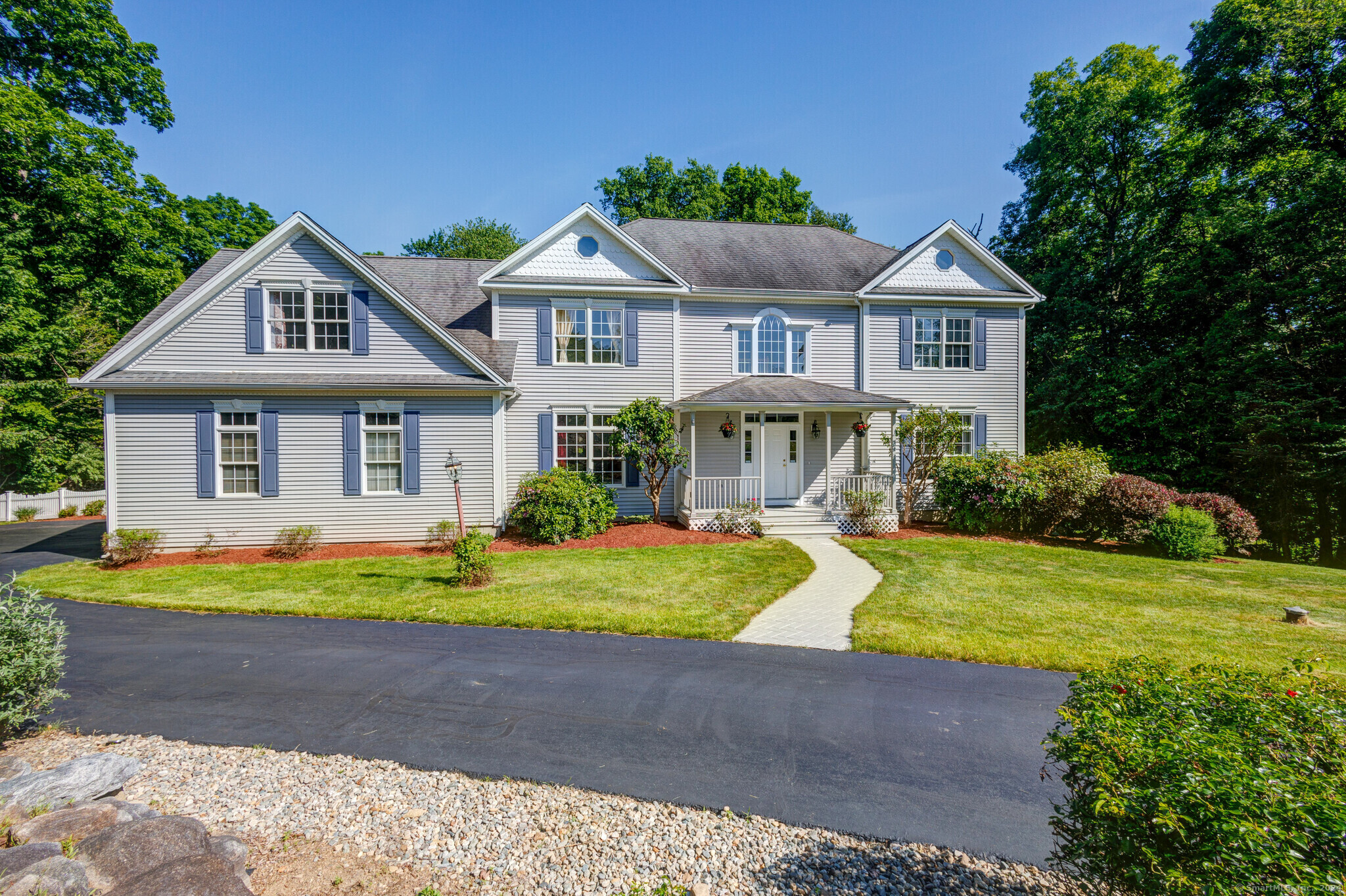 a front view of a house with a yard table and chairs