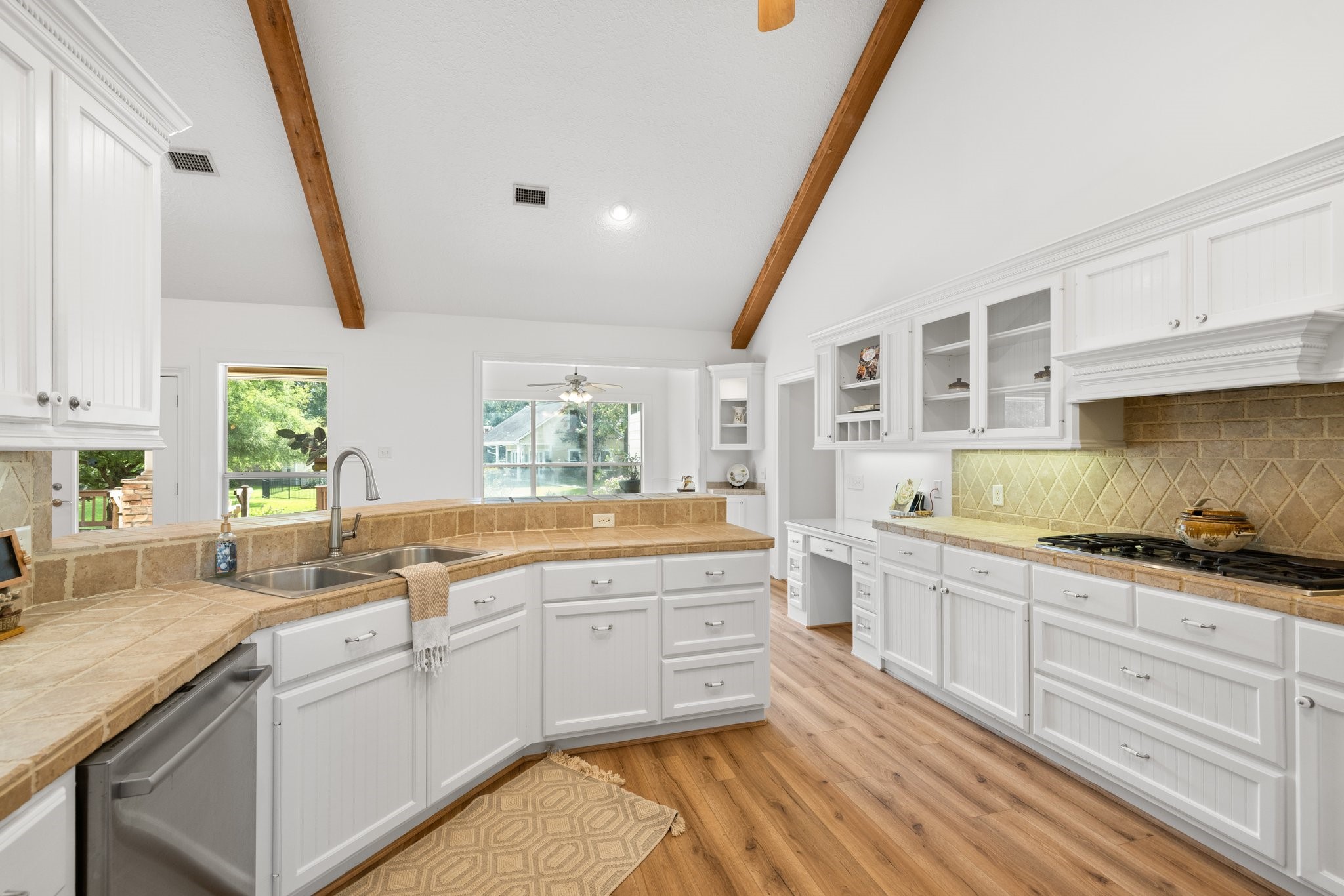 34310 High Point Drive Magnolia, TX 77355 - Photo 11 of 48 This kitchen features abundant cabinets for storage, expansive counters for meal prep, and a convenient desk for organizing recipes or handling bills.