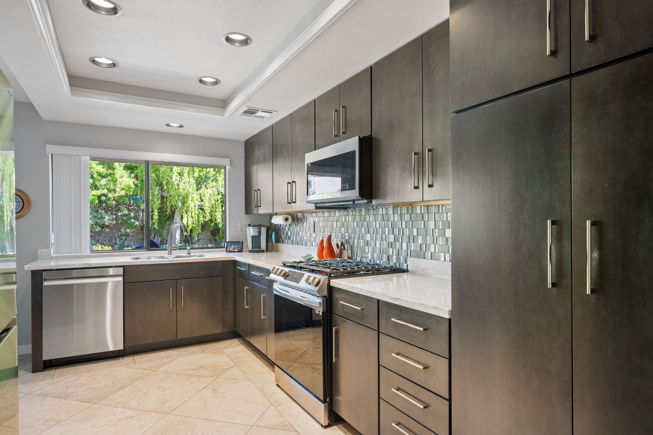 68640 Calle Mancha Cathedral City, CA 92234 - Photo 17 of 54 a kitchen with a sink cabinets and window