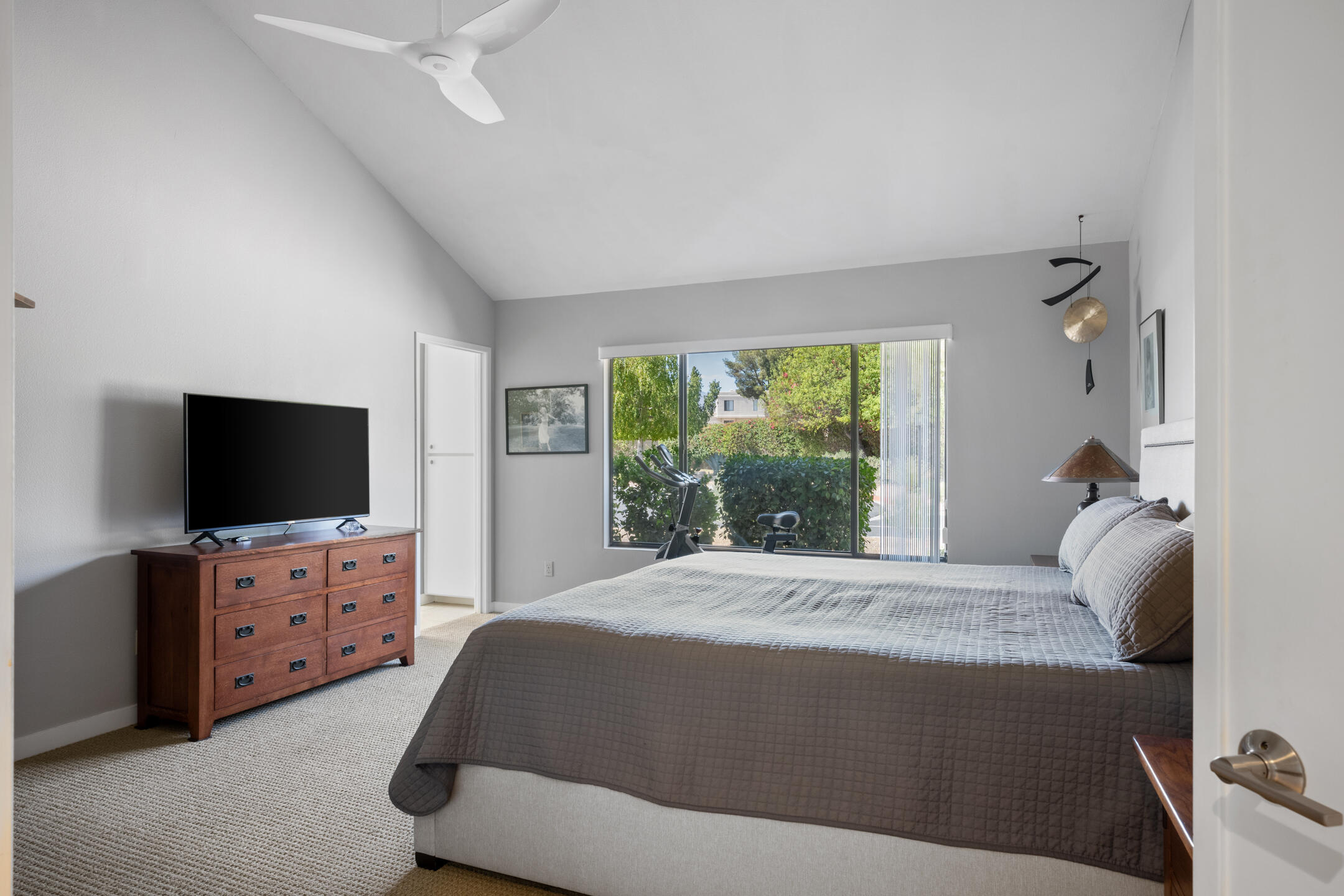 68640 Calle Mancha Cathedral City, CA 92234 - Photo 21 of 54 a bedroom with a bed and a flat tv screen on wall