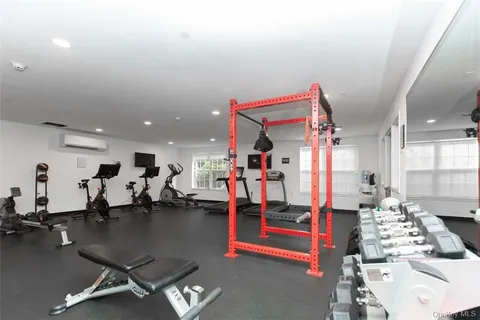a gym room with lots of gym equipment