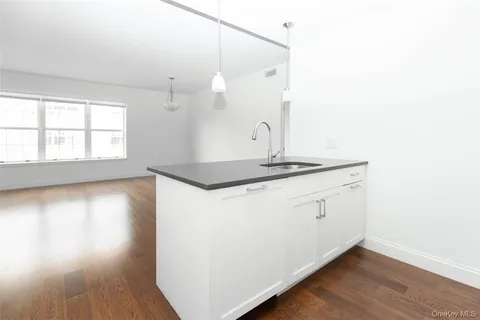 a view of kitchen and hall with wooden floor