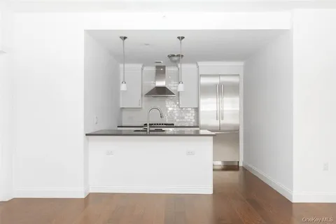 a kitchen with granite countertop a sink and cabinets