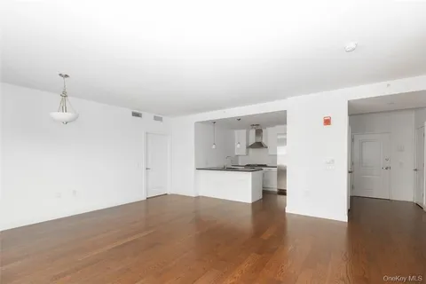 a view of a kitchen with wooden floor and a sink