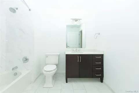 a bathroom with a sink a toilet and bathtub