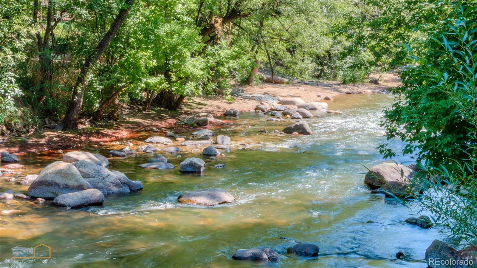 441 Arapahoe Avenue Boulder, CO 80302 - Photo 17 of 40 a view of a lake with lawn chairs
