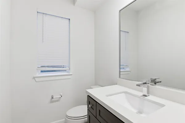 a bathroom with a sink toilet and vanity