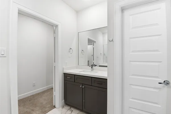 a bathroom with a sink a mirror and a vanity