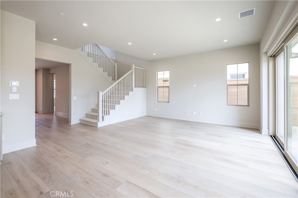 118 Mossvine Irvine, CA 92618 - Photo 7 of 31 an empty room with wooden floor and windows