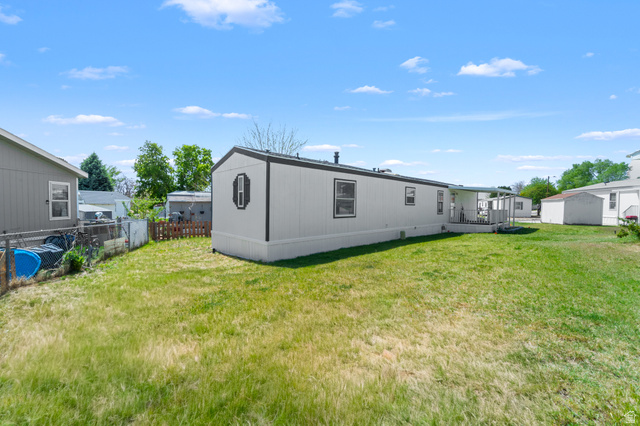 2600 North Hill Field Road, Unit 103A Layton, UT 84041 - Photo 3 of 31 White manufactured home with a black trim accent on the end cap, featuring multiple windows