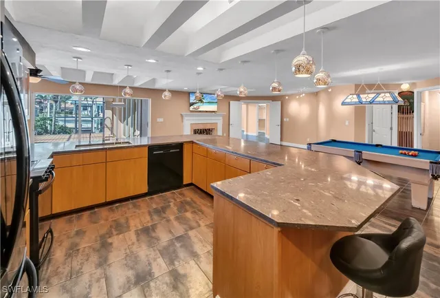 a kitchen with stainless steel appliances granite countertop a sink and a stove