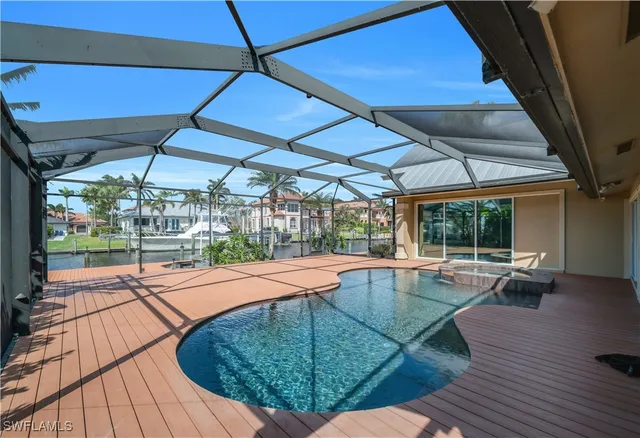 a view of a backyard with table and chairs under an umbrella