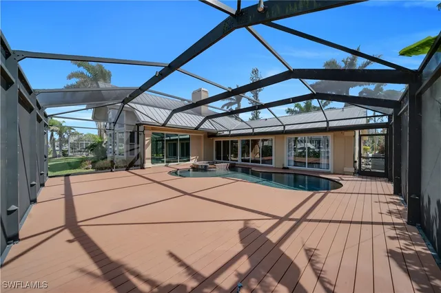 a view of a patio with table and chairs under an umbrella