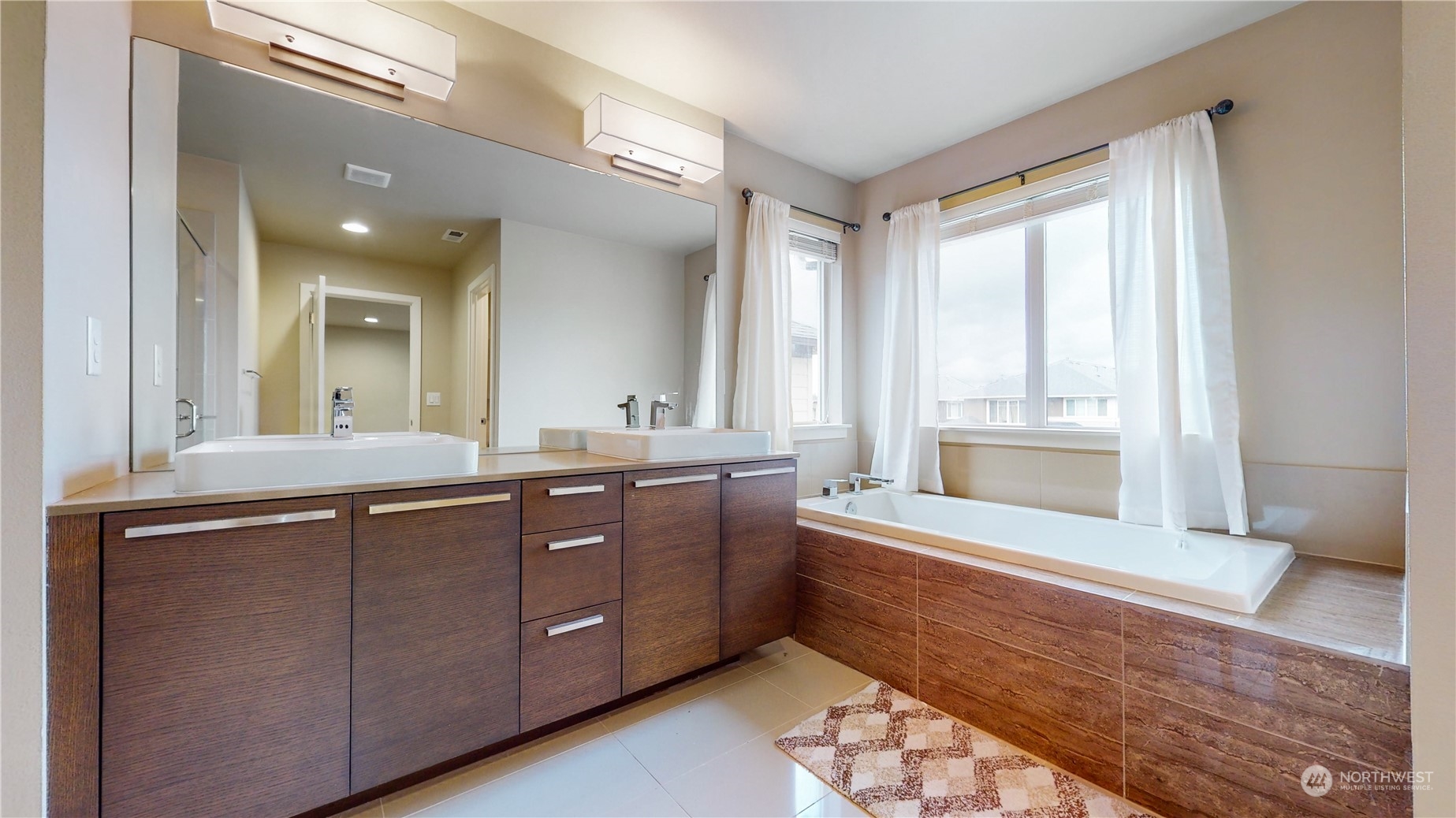 17009 42nd Drive Southeast Bothell, WA 98012 - Photo 14 of 26 a bathroom with a double vanity sink and a bathtub